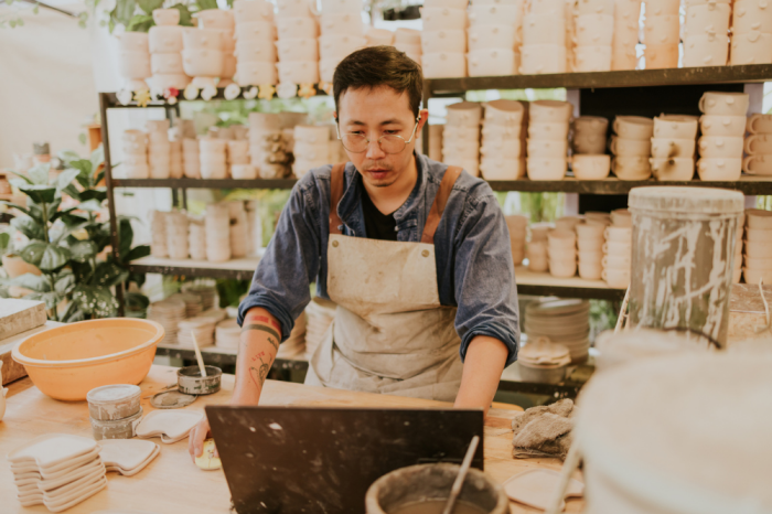 An image of a local business owner in his pottery workshop