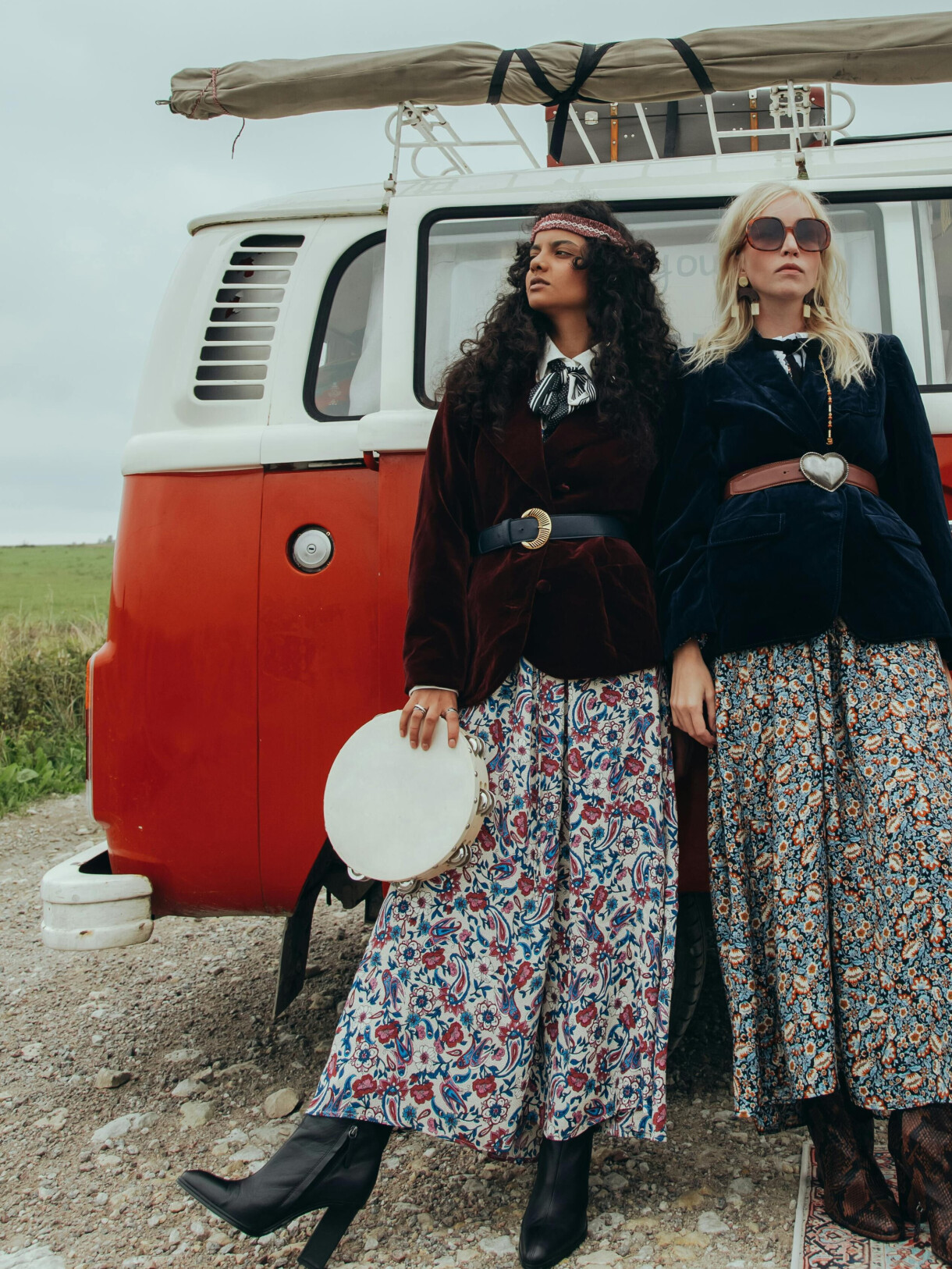 two fashion models wearing flowery skirts and belted jackets